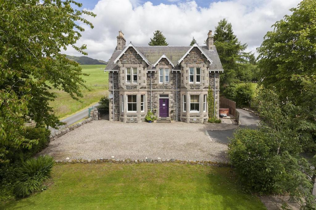 an aerial view of a house with a yard at Kinnaird Country House in Pitlochry