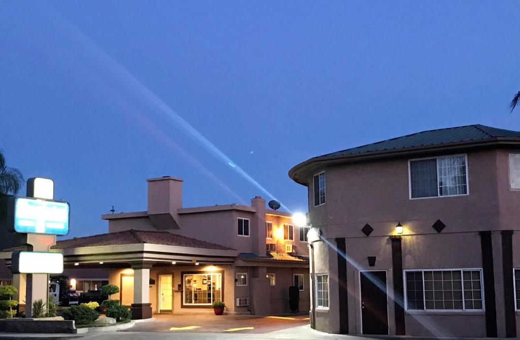 a house with a street sign in front of it at Travelodge by Wyndham Merced Yosemite in Merced