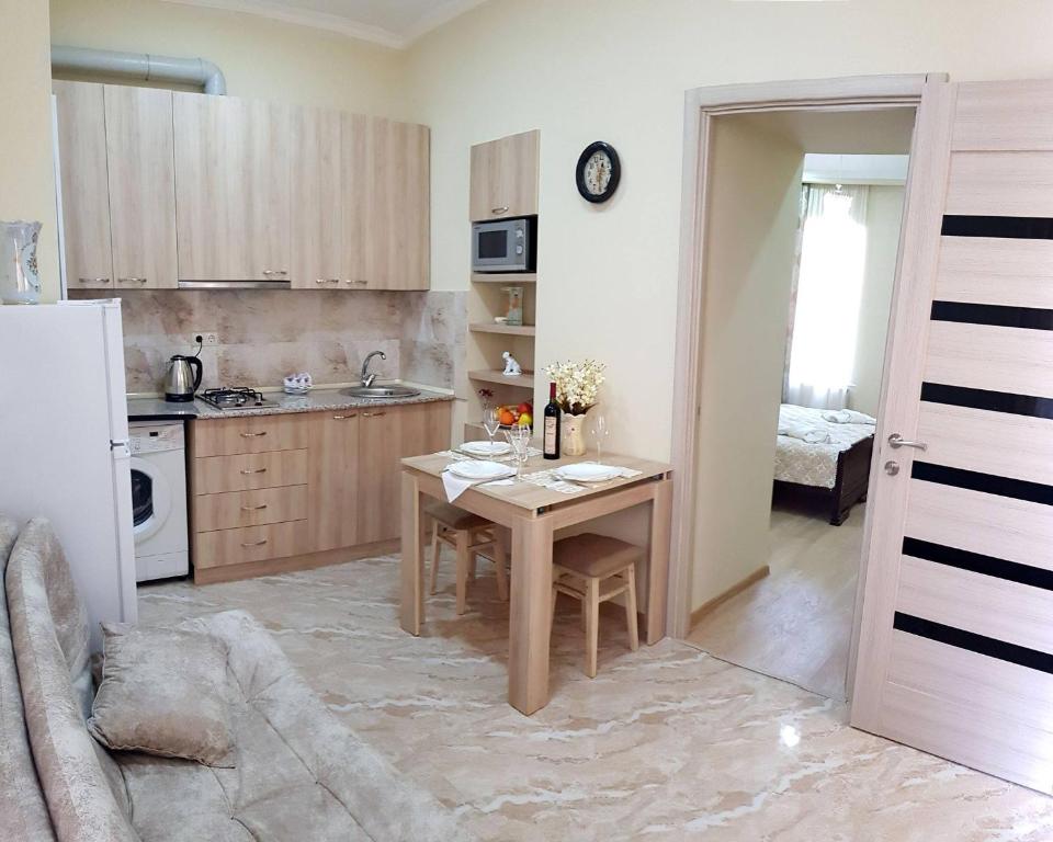uma pequena cozinha com uma mesa e um frigorífico em Apartament Old Avlabar em Tbilisi