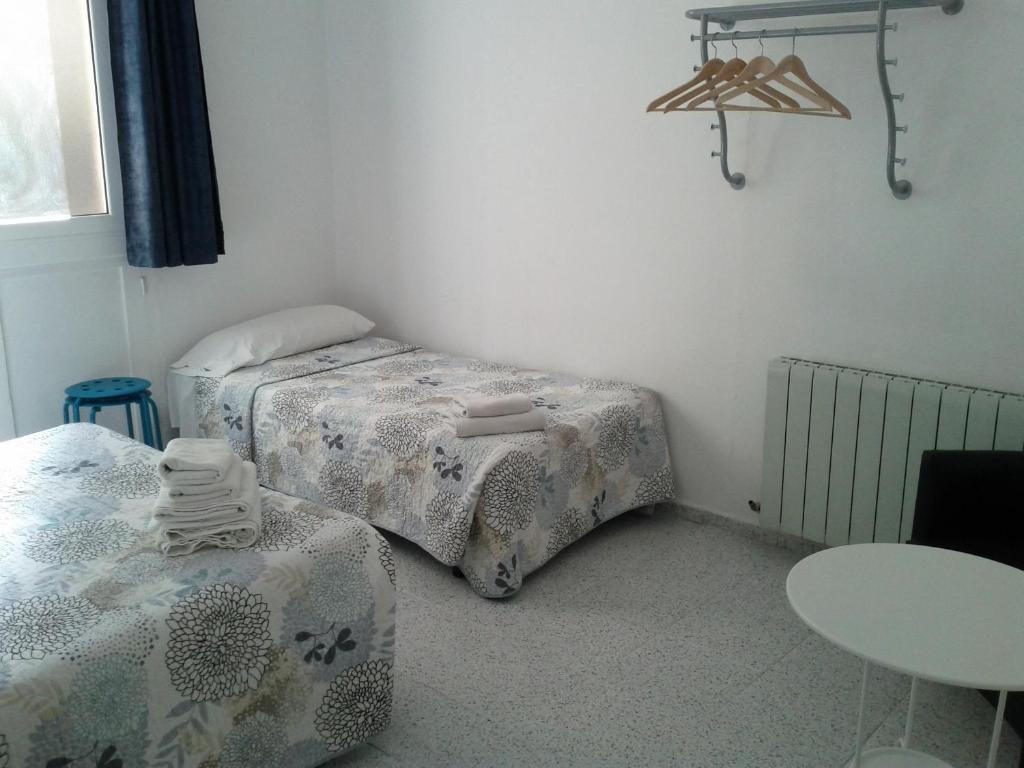 Postel nebo postele na pokoji v ubytování Hostal River