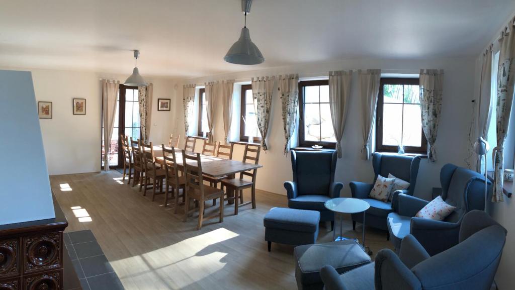 a living room with blue chairs and a table at Apartmány Sportrelax in Albrechtice v Jizerských horách