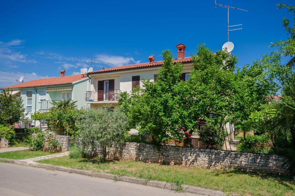 a house on the side of the road at Apartments Milan in Poreč