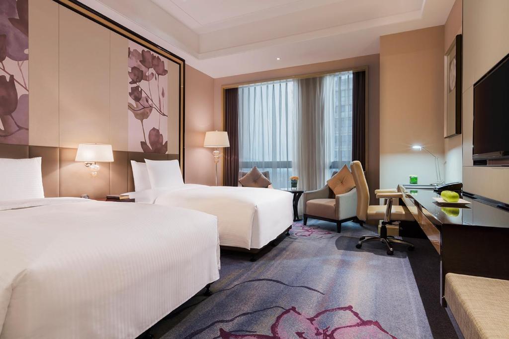 Postel nebo postele na pokoji v ubytování Wanda Realm Guangzhou Zengcheng
