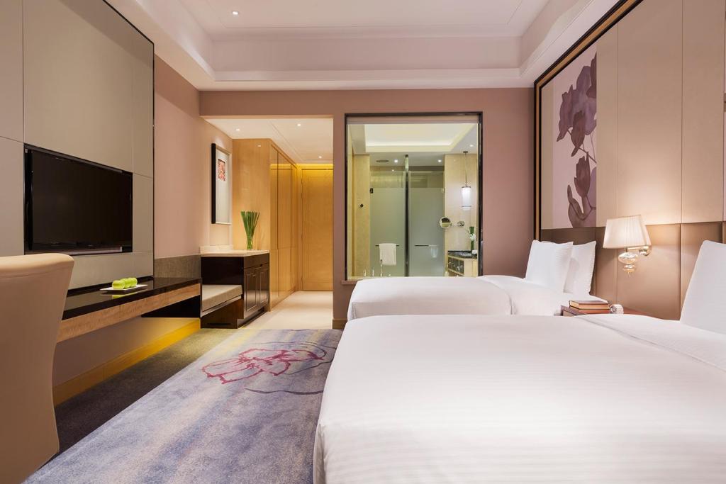 Postel nebo postele na pokoji v ubytování Wanda Realm Guangzhou Zengcheng