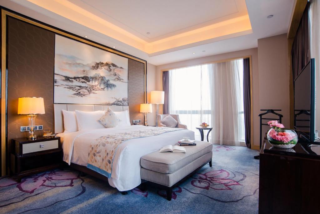 Postel nebo postele na pokoji v ubytování Wanda Realm Guangzhou Zengcheng