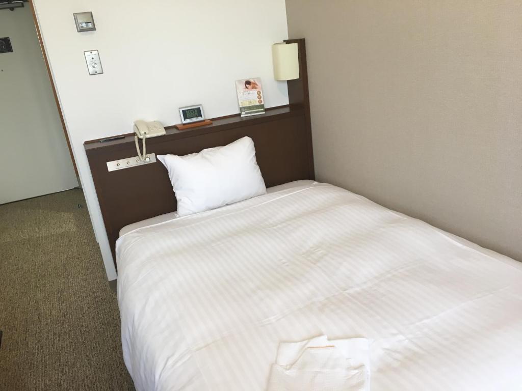 Postel nebo postele na pokoji v ubytování KKR Hotel Nagoya