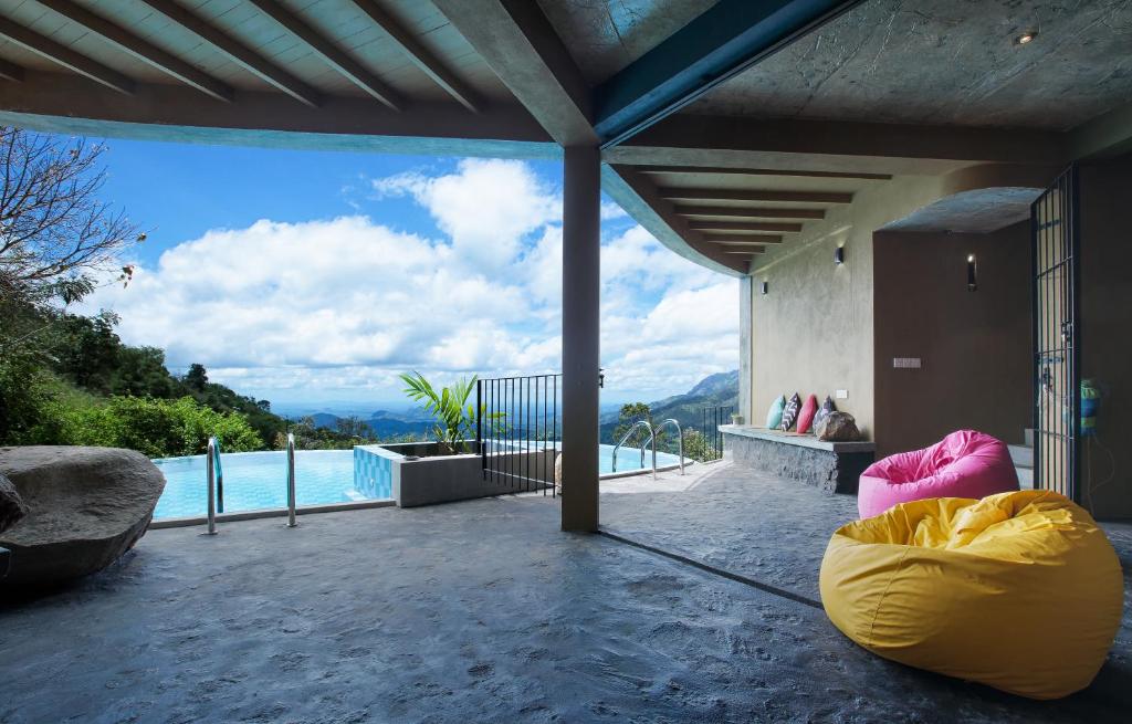 a patio with a large yellow bean bag chair next to a pool at Villa Verde Ella in Ella