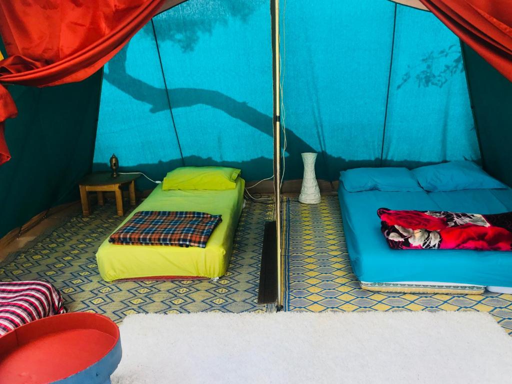 a room with two beds in a tent at Gite Le Nomade in Mirleft