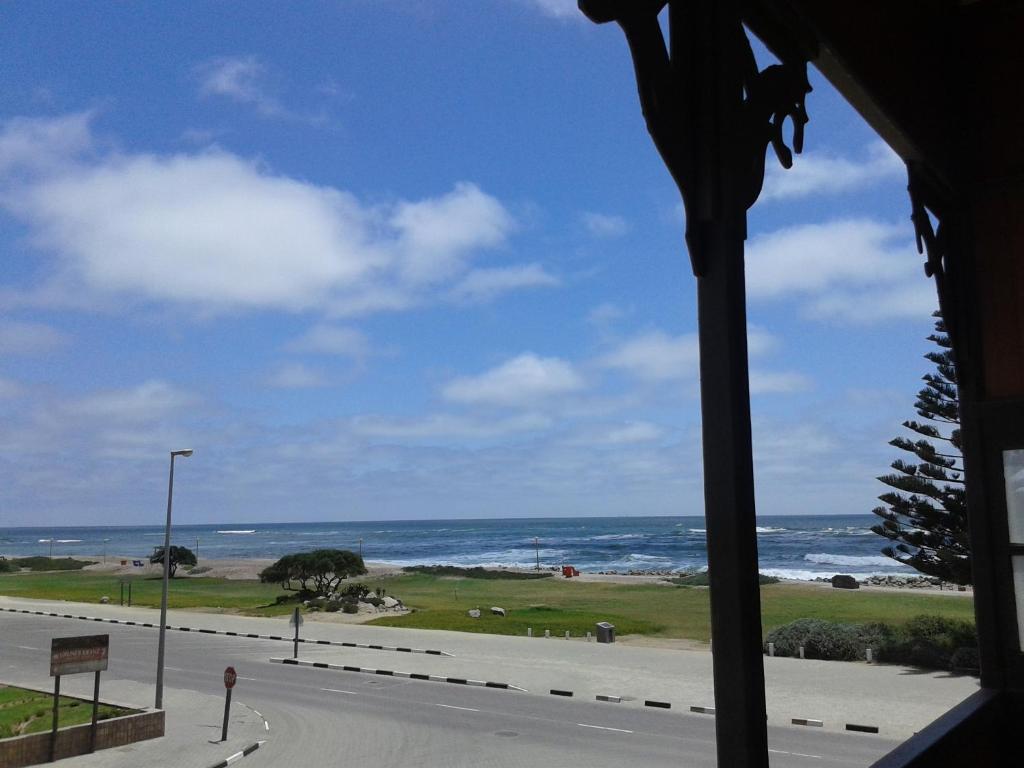 a view of a road and the ocean from a window at Jetty Self-Catering in Swakopmund