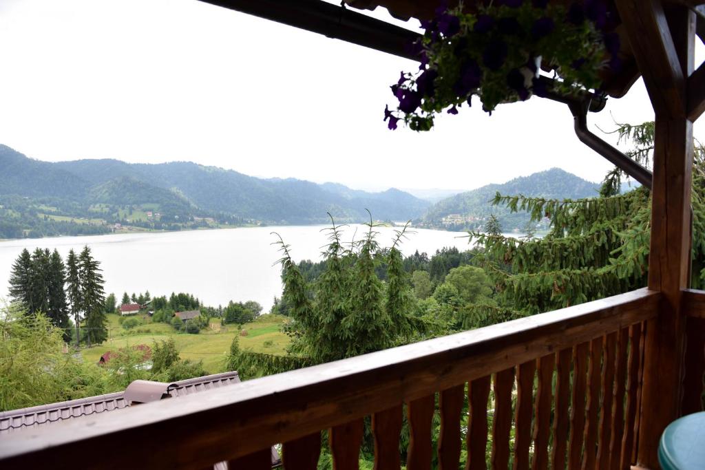 a balcony with a view of a lake and mountains at Casa Edy in Colibiţa