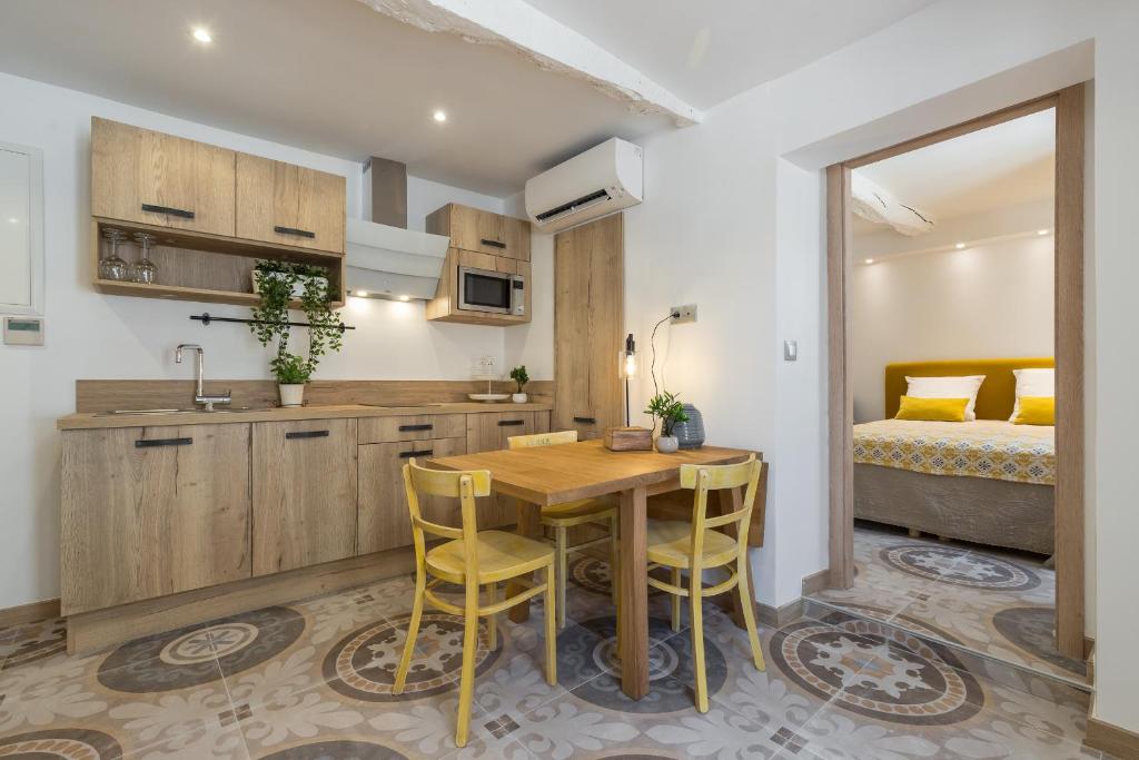 a kitchen and dining room with a table and chairs at Valbonne Flat in Valbonne