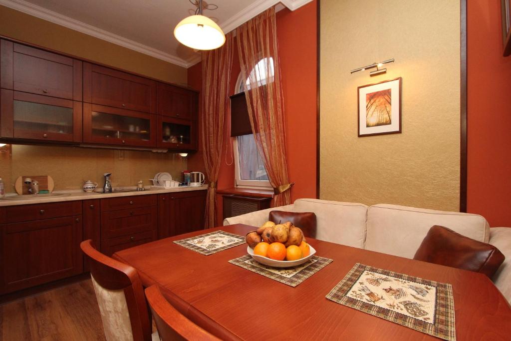 a kitchen with a table with a bowl of fruit on it at Mirage Apartment in Hévíz