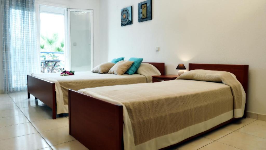 Postel nebo postele na pokoji v ubytování Asterias Hotel