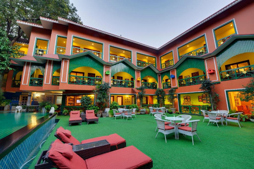 a large building with a pool and tables and chairs at Mayfair Rourkela in Panposh