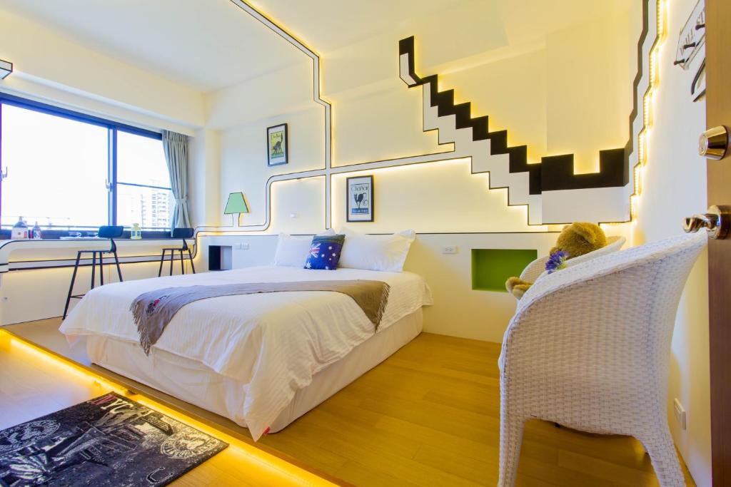 a bedroom with a large bed and a staircase at 宜蘭F1包棟 villa in Wujie