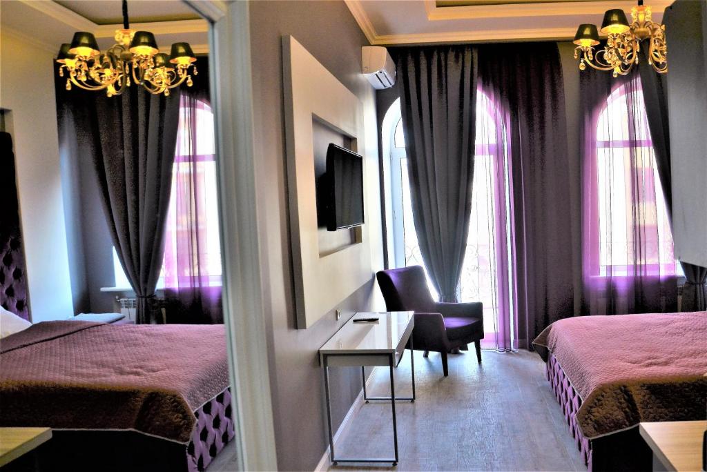 a hotel room with two beds and a mirror at Kiev City Center in Kyiv