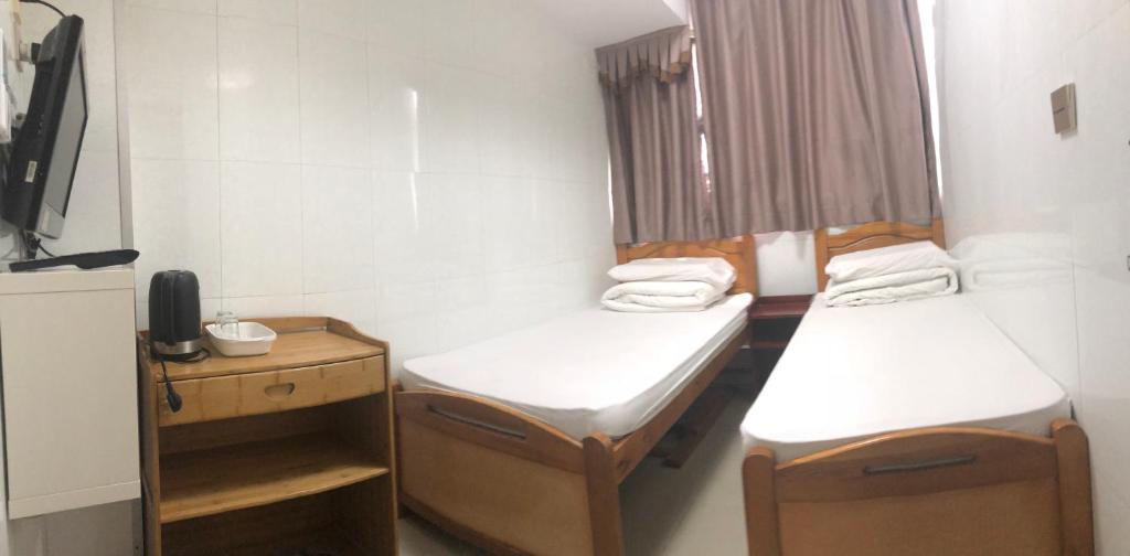 Postel nebo postele na pokoji v ubytování Hung Fai Guest House