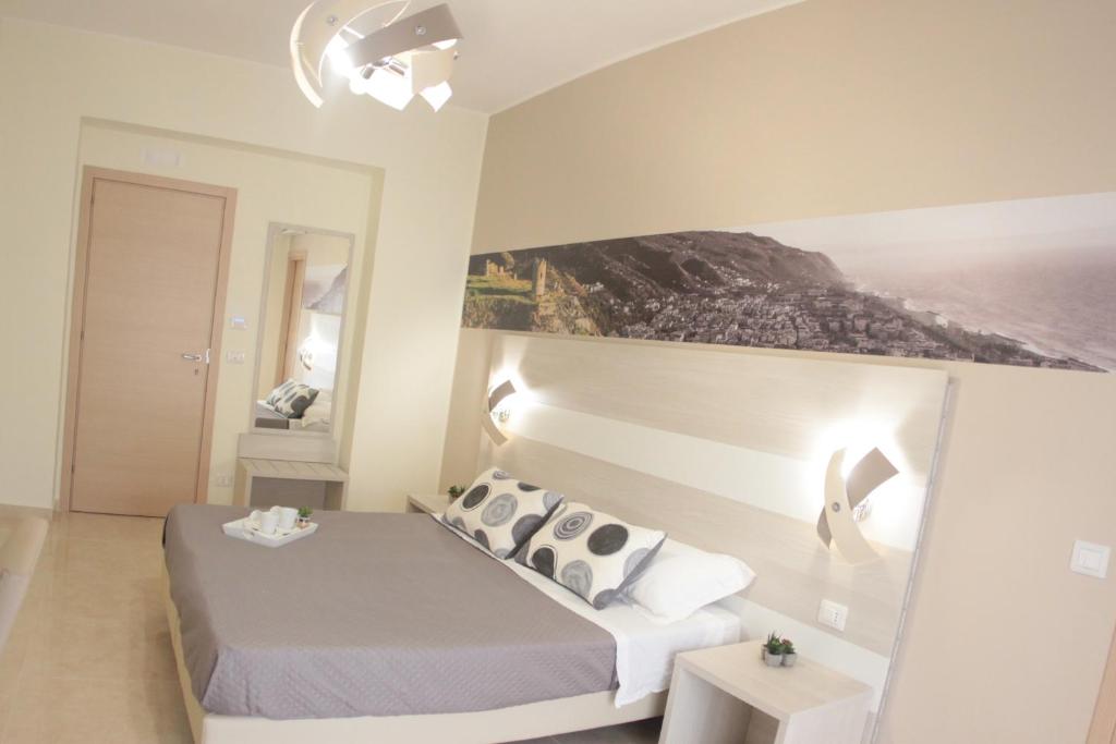 Postel nebo postele na pokoji v ubytování A'MANTIA HOTEL