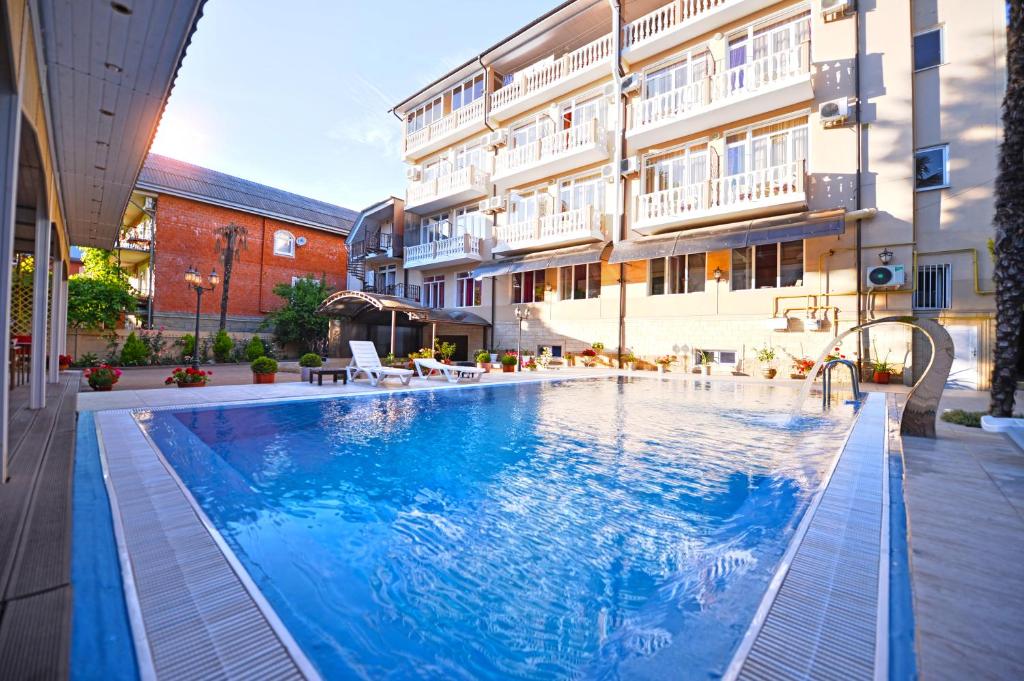 a large swimming pool in front of a building at Katran Hotel in Lazarevskoye