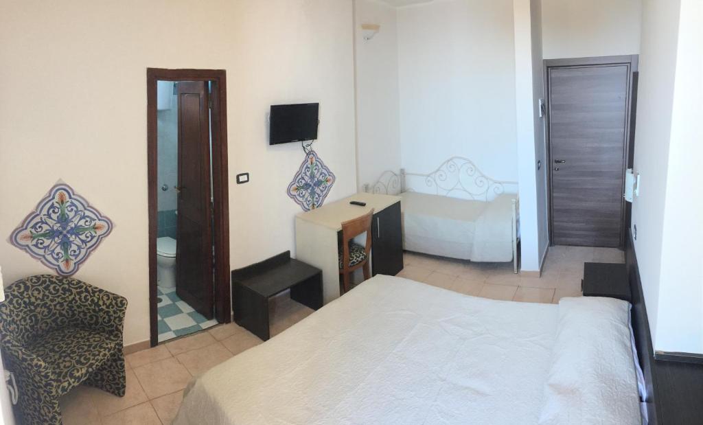 Postel nebo postele na pokoji v ubytování Hotel Normanni
