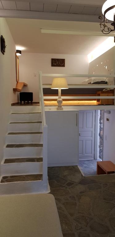 a stairway leading to a room with a bunk bed at Vrahos Boutique Hotel in Karavostasi