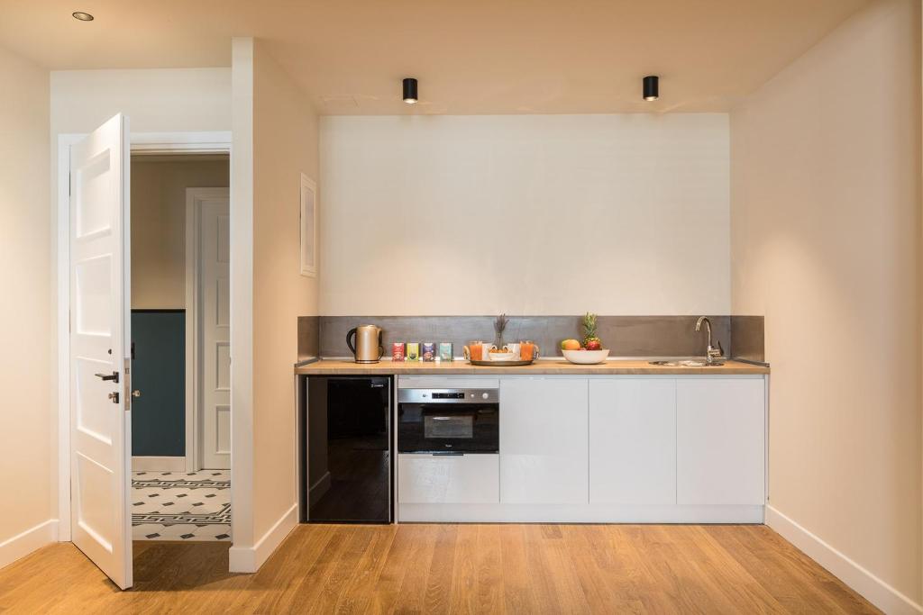 Kuchyň nebo kuchyňský kout v ubytování Klepsydra Urban Suites
