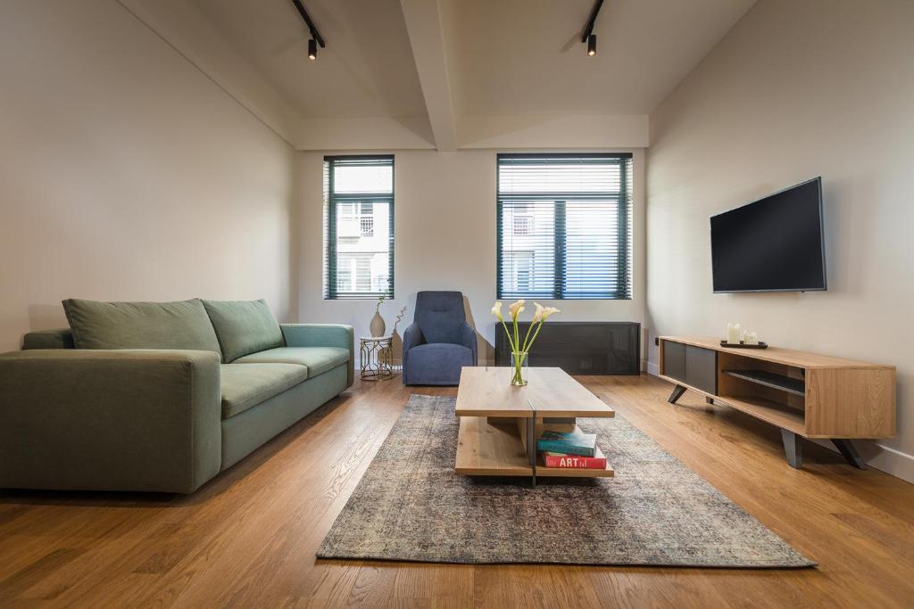 TV a/nebo společenská místnost v ubytování Klepsydra Urban Suites