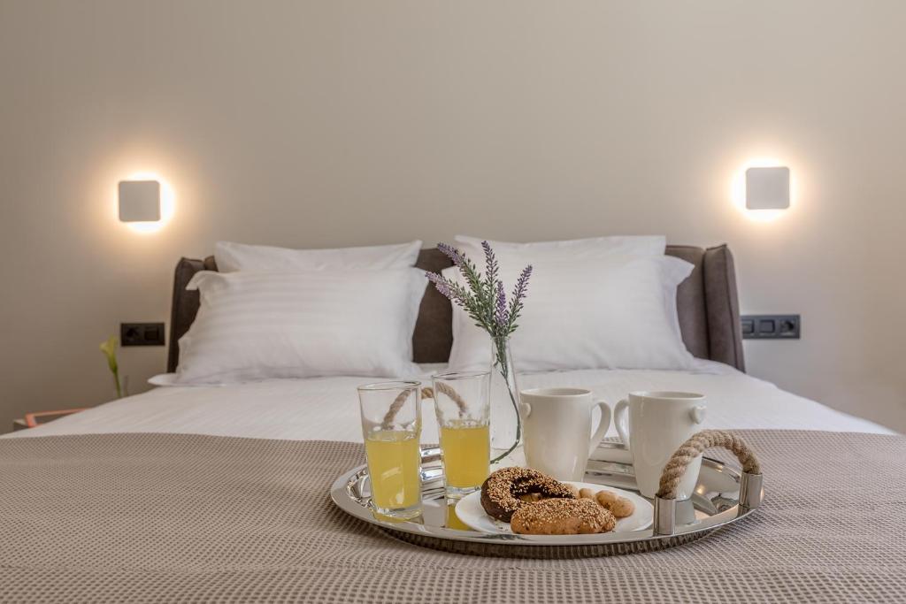 Postel nebo postele na pokoji v ubytování Klepsydra Urban Suites