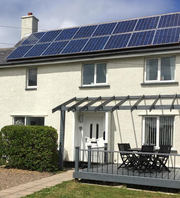 a house with solar panels on the roof at Craster Crew House in Craster
