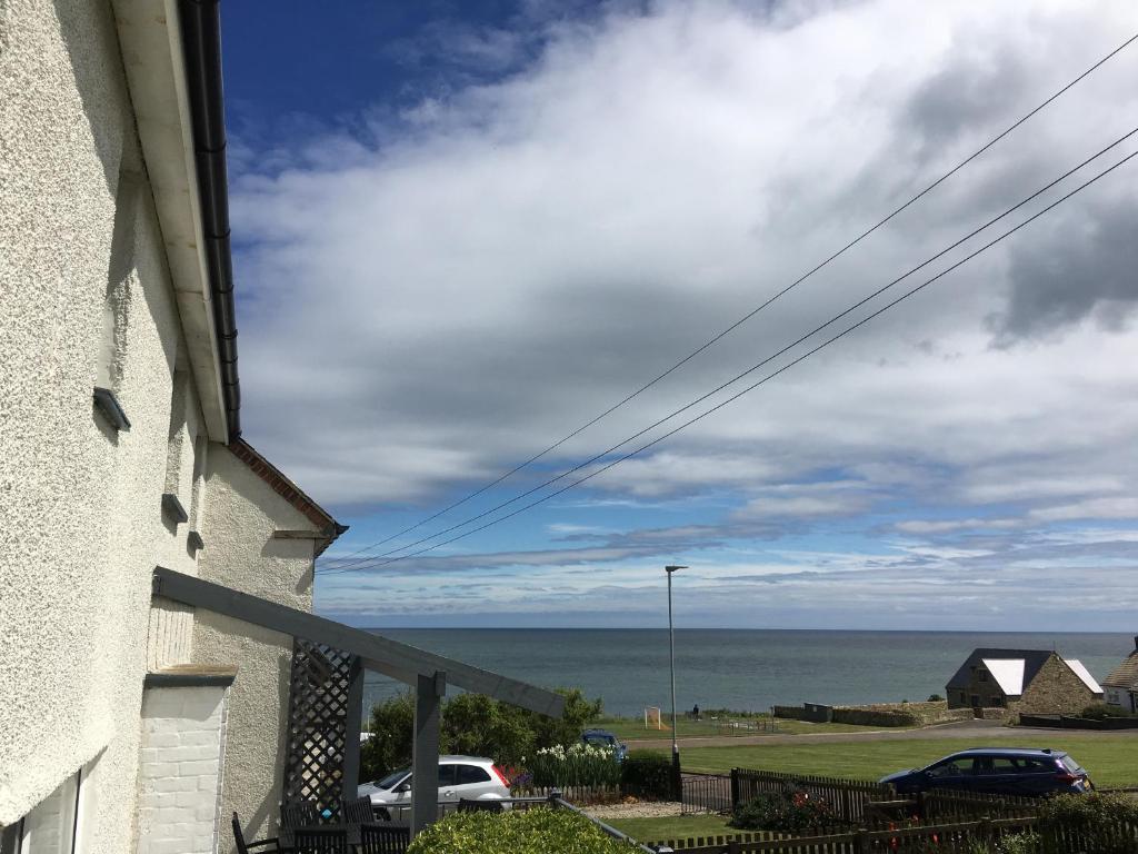 a view of the ocean from a house at Craster Crew House in Craster