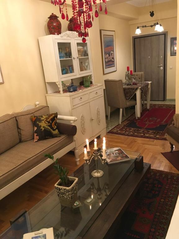 a living room with a couch and a table at Art island house in Athens