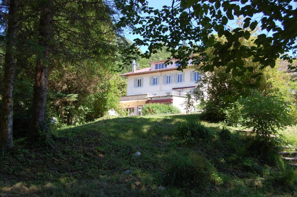 a house in the middle of a field with trees at Joly Saint Sauveur in Villard-Saint-Sauveur