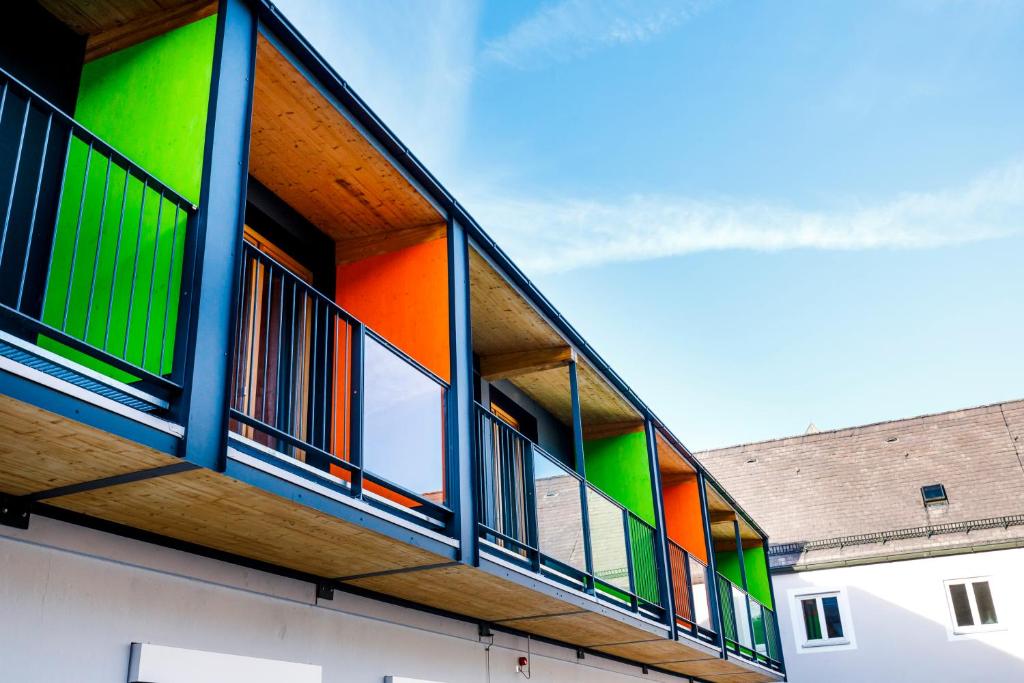 a building with colorful balconies on the side of it at Jugendherberge Burghausen in Burghausen