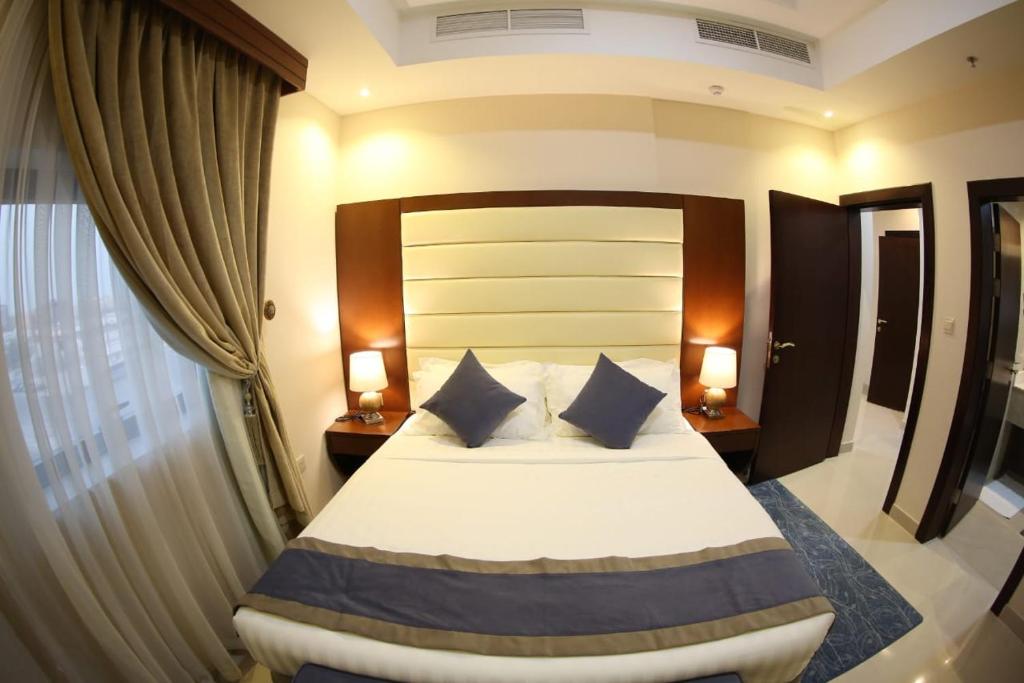 Postel nebo postele na pokoji v ubytování SAS Al Olaya Hotel Suites
