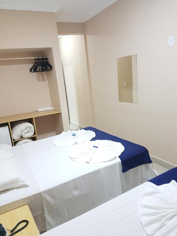 Postel nebo postele na pokoji v ubytování Hotel Astória Maringá