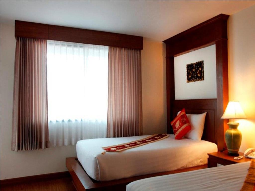 Postel nebo postele na pokoji v ubytování Baan Yuree Resort & Spa - SHA Plus