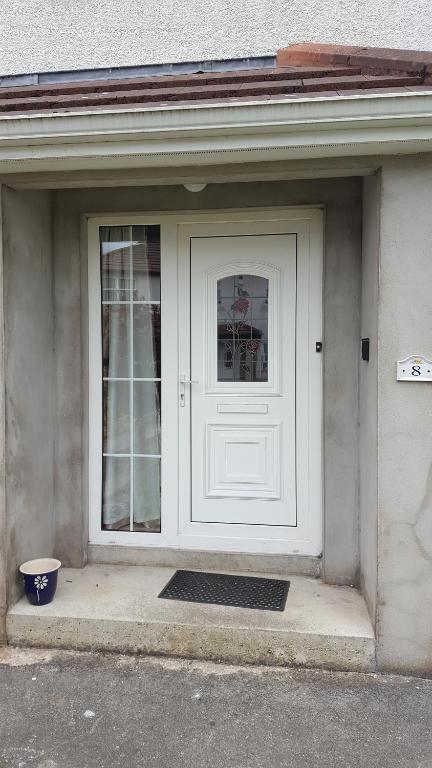 a white door of a house with a window at Laurelbrook Town House in Magherafelt