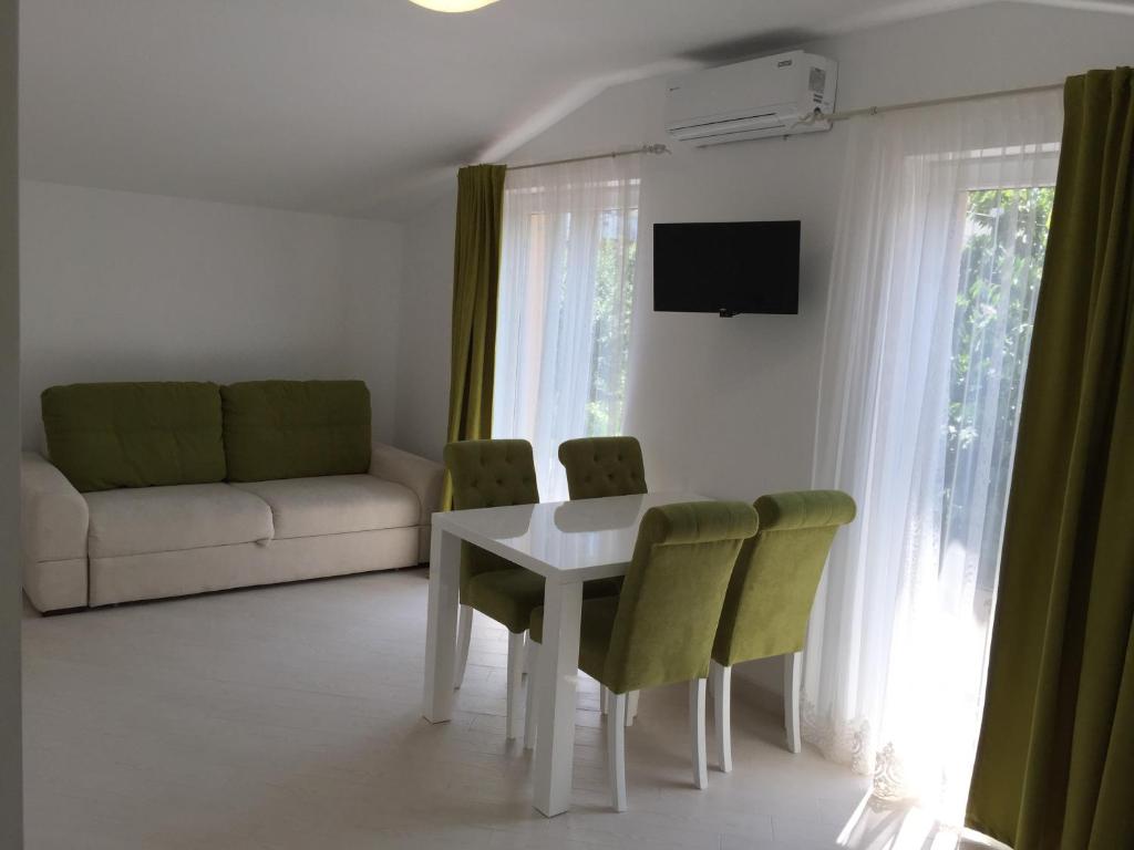 a living room with a white table and chairs at Guest House in Mukacheve