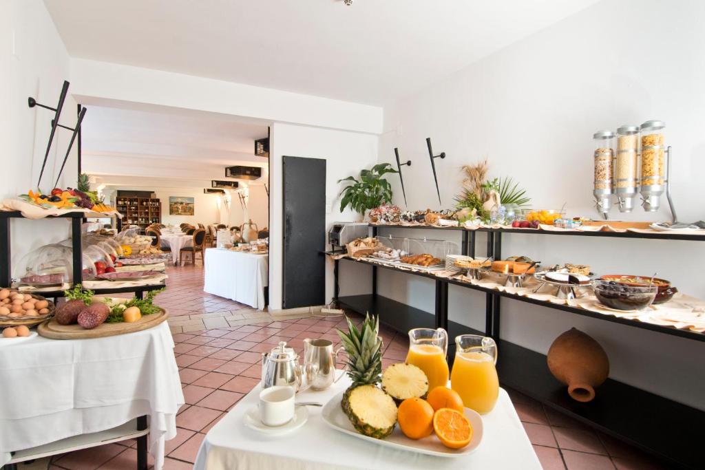a breakfast room with a buffet of food on tables at Grand Hotel Masseria Santa Lucia in Ostuni