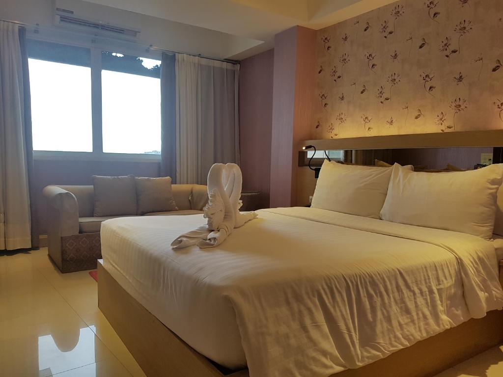 Postel nebo postele na pokoji v ubytování Kavin Buri Green Hotel
