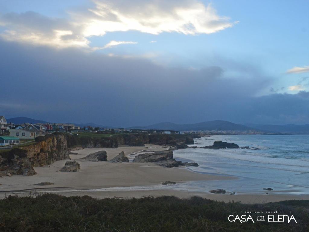 a view of a beach with rocks and the ocean at Casa Elena Turismo Rural in Reinante