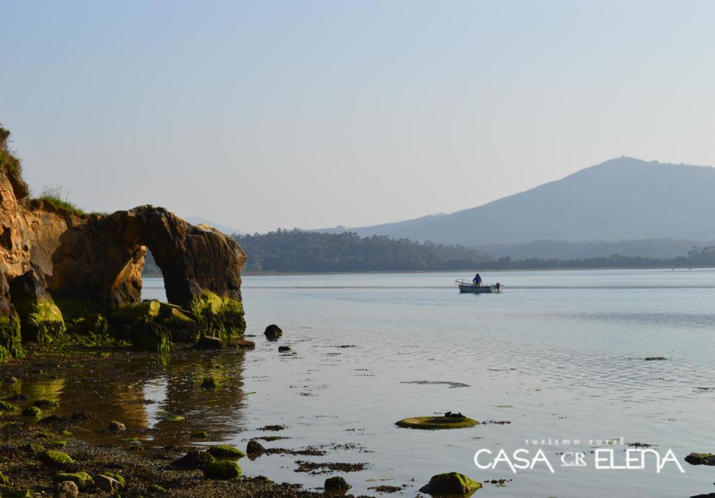 a person in a boat on the water at Casa Elena Turismo Rural in Reinante