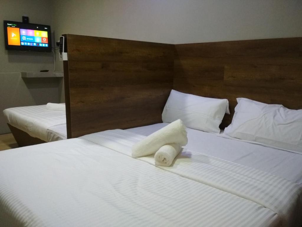 Voodi või voodid majutusasutuse Qing Yun Rest House Gadong, Brunei Darussalam toas