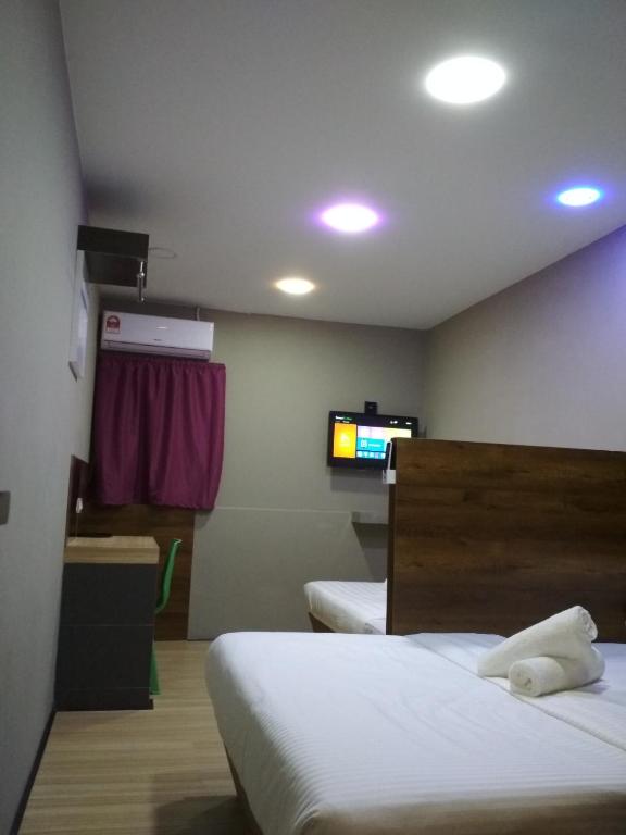 Voodi või voodid majutusasutuse Qing Yun Rest House Gadong, Brunei Darussalam toas