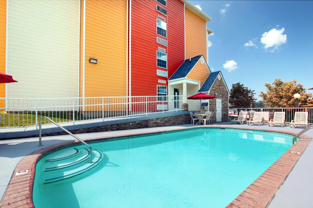 a large swimming pool in front of a building at Microtel Inn & Suites by Wyndham Pigeon Forge in Pigeon Forge