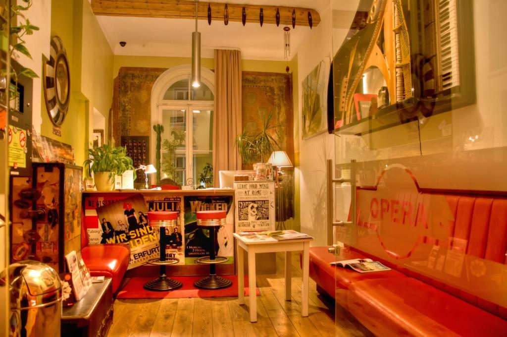 a living room with a couch and a table at OPERA Hostel in Erfurt