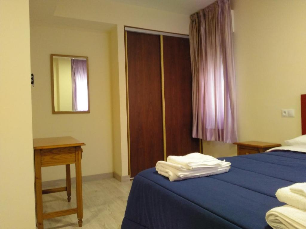 A bed or beds in a room at Hostal Orly