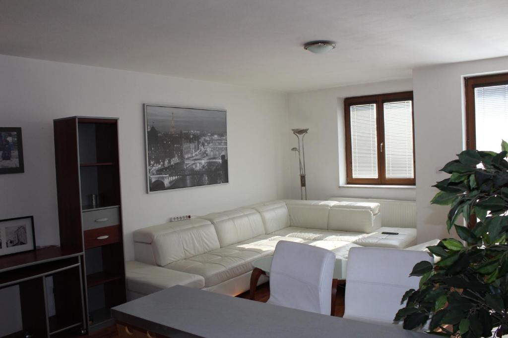 a living room with a white couch and a table at Nice apartment in Old Town in Bratislava