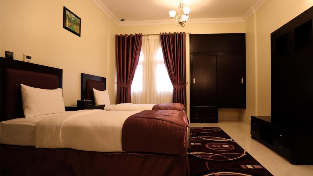 Postel nebo postele na pokoji v ubytování Remas Hotel Suites - Al Khoudh, Seeb, Muscat