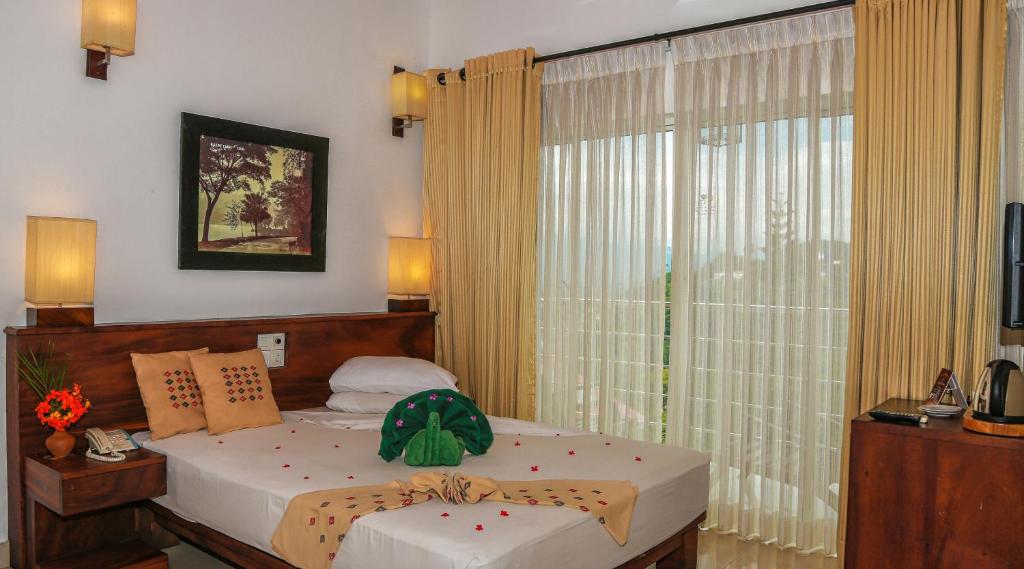 Postel nebo postele na pokoji v ubytování Senani Hotel